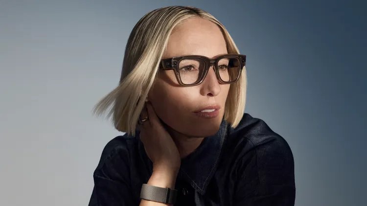 A person wearing the real Meta Ray-Ban Display glasses with the Meta Neural Band on her wrist