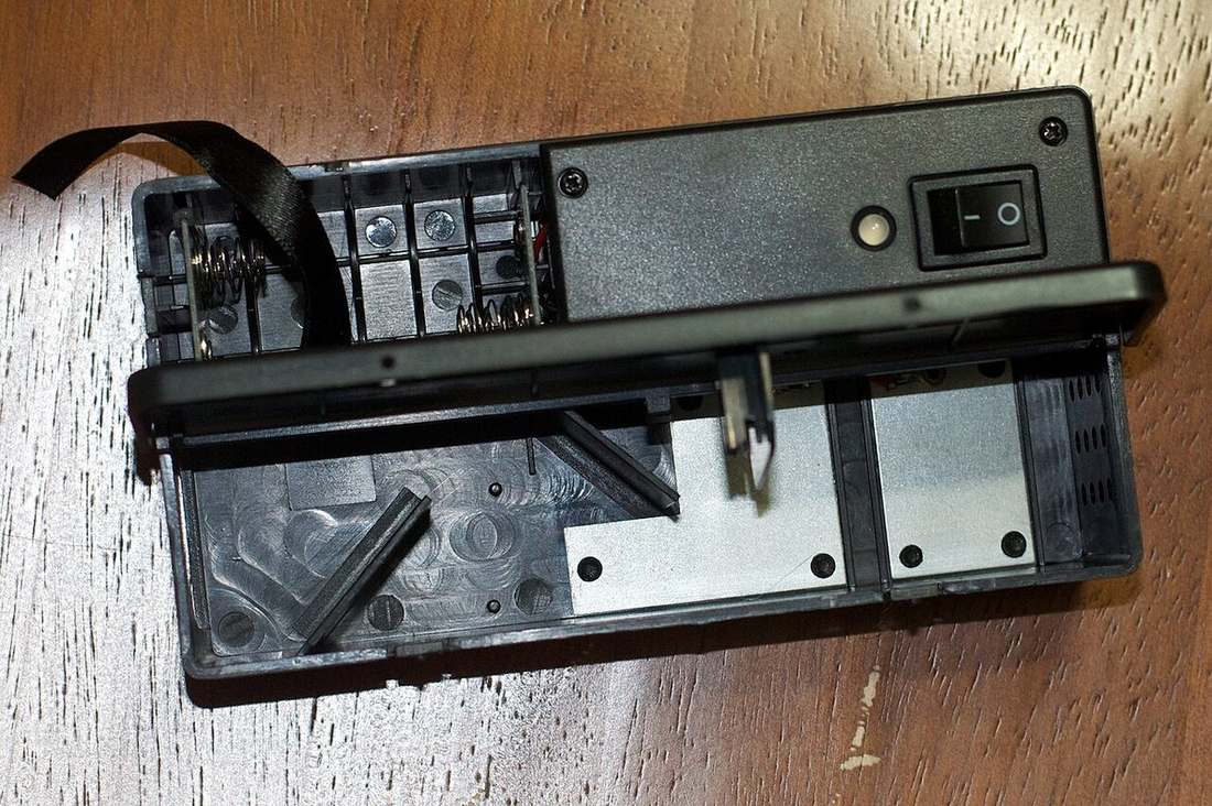 An electronic mouse trap opened to show the enclosed kill chamber and on-off switch, for a no-touch catch